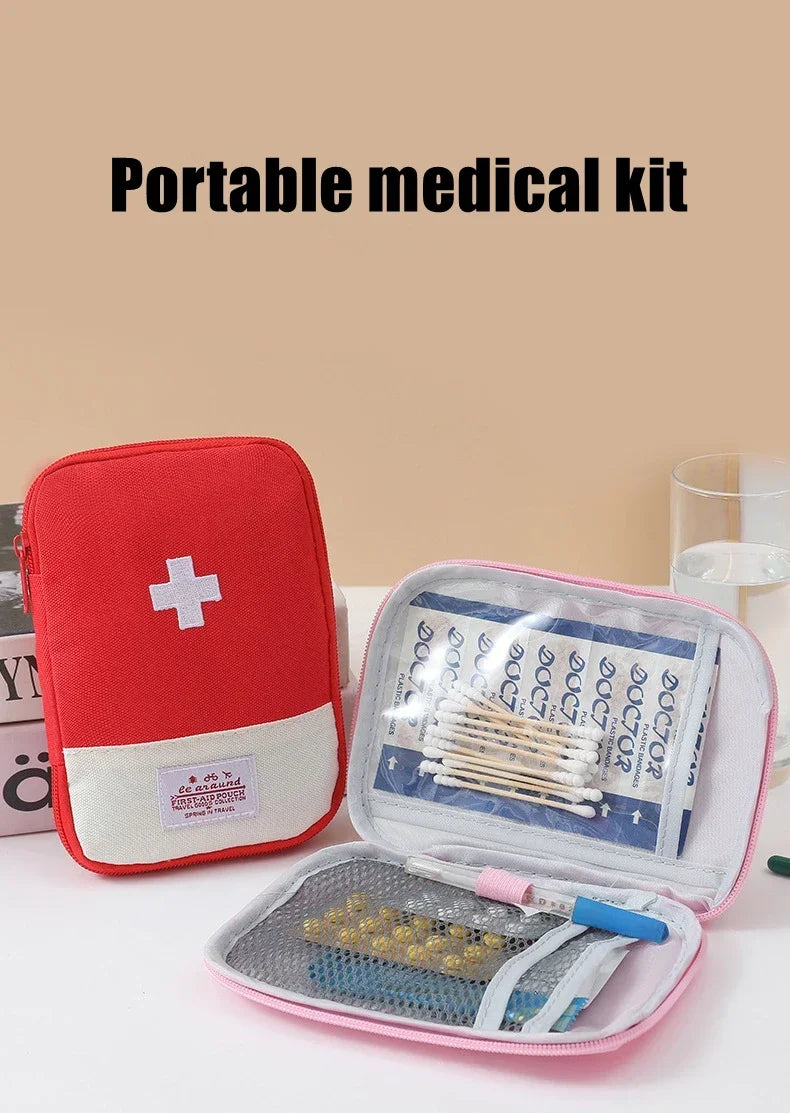 A red portable medical kit organizer bag with a clear lid showing various medical supplies like bandages and gauze.