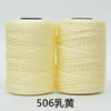 Spool of light yellow 3-ply polyester knitting yarn for crochet and hand crafts