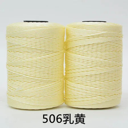 Spool of light yellow 3-ply polyester knitting yarn for crochet and hand crafts
