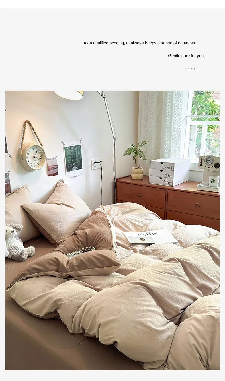 A bed with a beige duvet cover set and pillows, next to a wooden dresser and a plant.