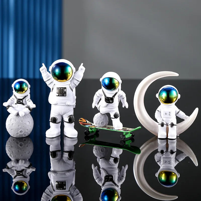A set of handcrafted astronaut figurines in white resin and glass eyes displayed on a reflective surface.