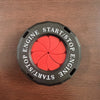 A black circular button cover with red accents and text reading START/STOP ENGINE.