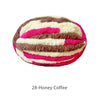 A ball of variegated chenille yarn in shades of pink, white, and brown for hand knitting.