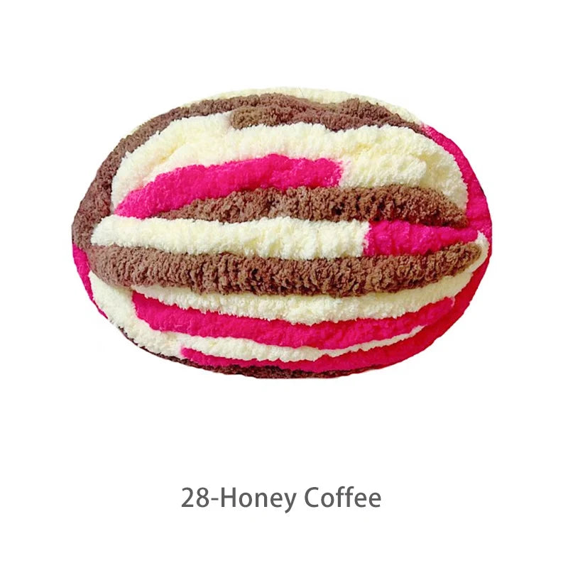 A ball of variegated chenille yarn in shades of pink, white, and brown for hand knitting.