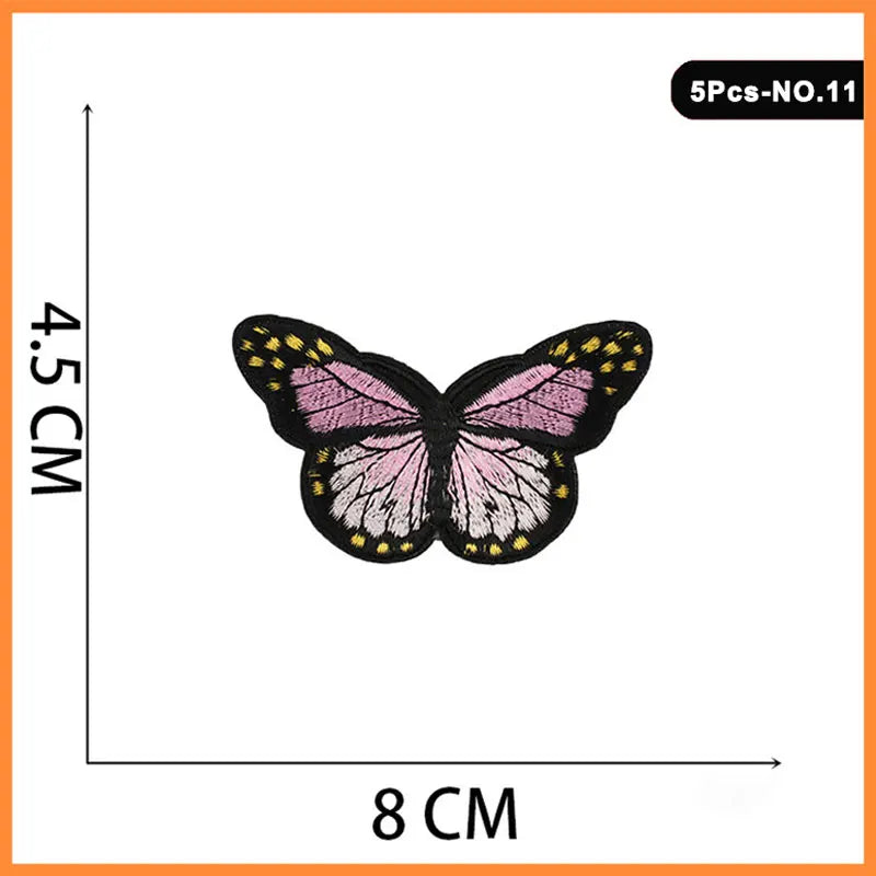 A butterfly and rose embroidered iron-on patch with pink, black, and yellow details.