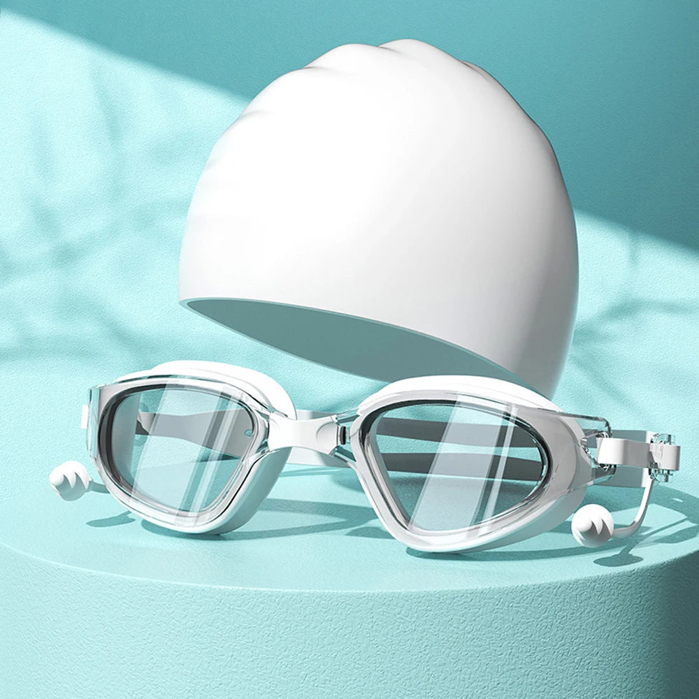 Unos lentes de natación transparentes descansando sobre una superficie azul claro con una luz blanca.