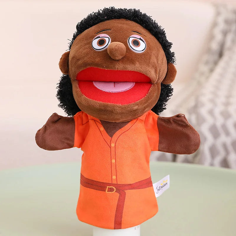A brown plush hand puppet with orange clothing and large eyes is shown against a light background.