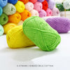 A pile of bright lime green 4-strand combed milk cotton yarn next to various colored yarns.