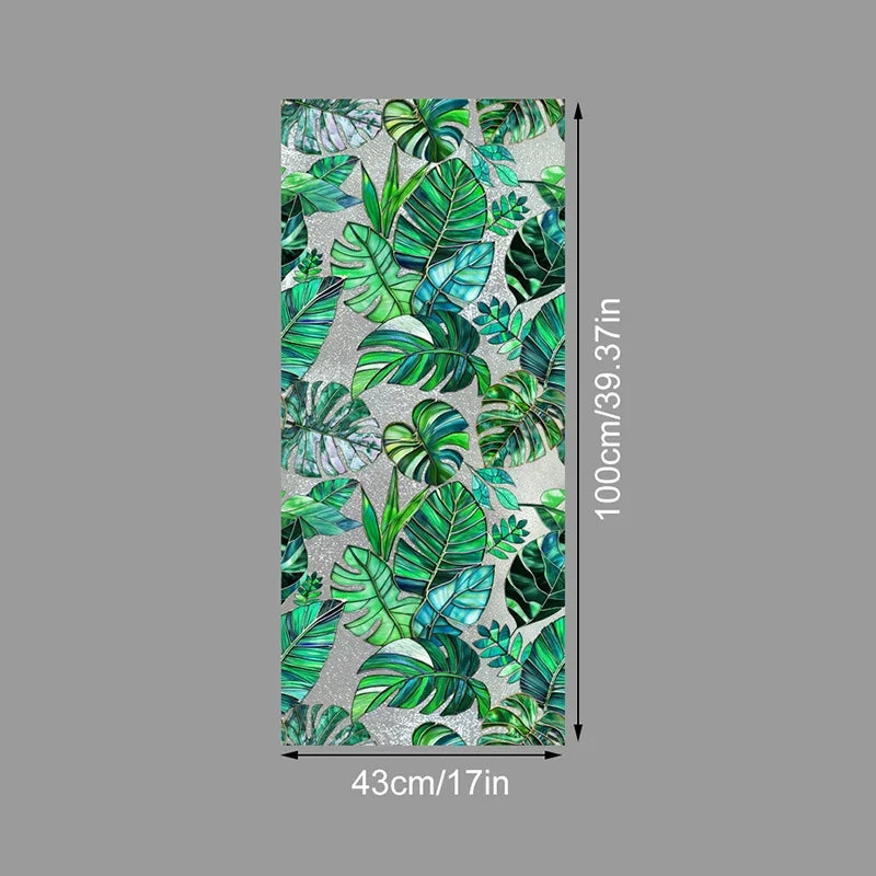 Vertical sheet of floral stained glass window film featuring green and teal leaves on a silver background