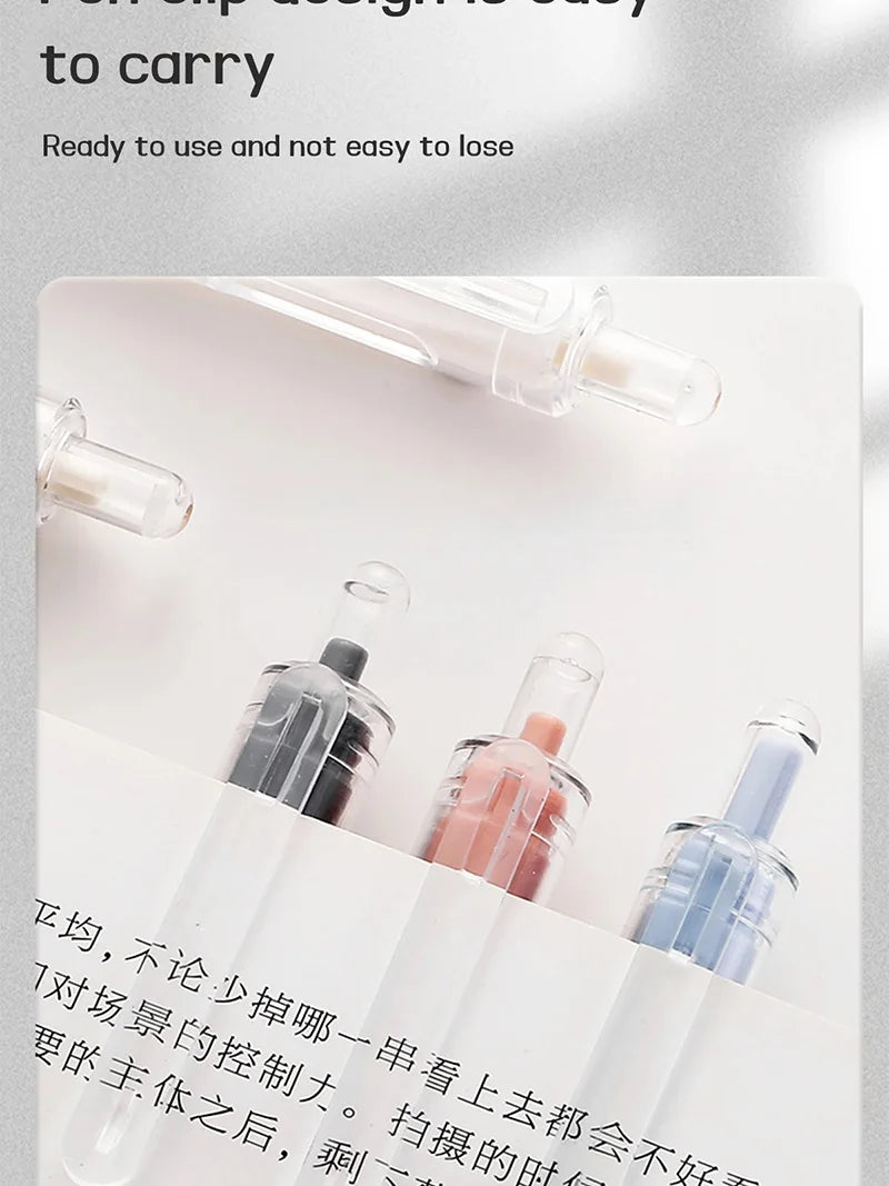A close-up shot of five retractable gel pens with various colored ink, displayed on a white background.