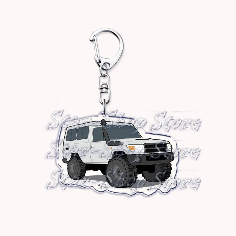 A silver metal key ring attached to a miniature off-road truck model.