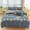 A navy blue bedding set featuring a star pattern with gold accents, including a duvet cover, fitted sheet, and pillows.