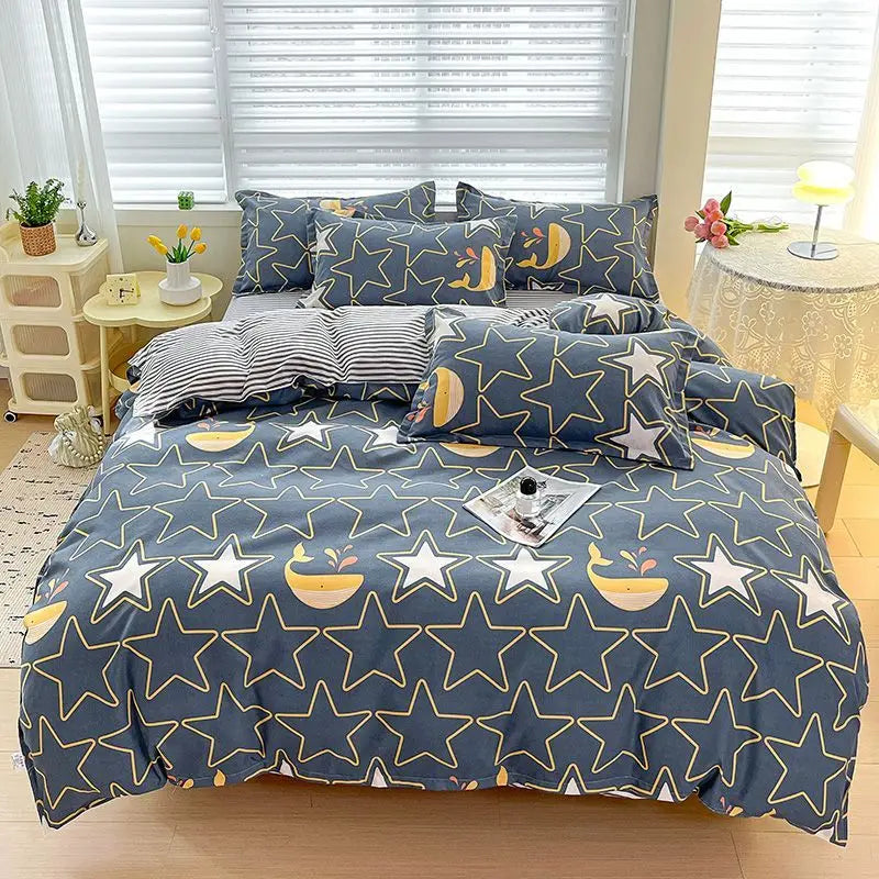 A navy blue bedding set featuring a star pattern with gold accents, including a duvet cover, fitted sheet, and pillows.