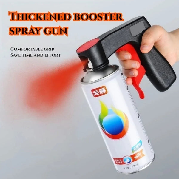 A hand is using a thickened booster spray gun to apply paint, showing the handle and the resulting spray.