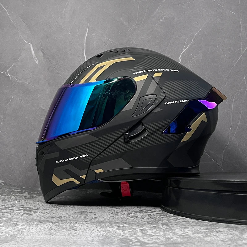 A black modular flip-up motorcycle helmet with a blue reflective visor displayed against a gray background.