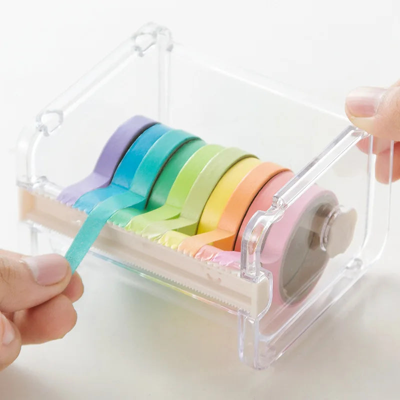 A hand is holding a colorful set of washi tape strips inside a clear plastic storage box.