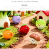 A collection of hand-painted resin vegetable figurines, including a purple eggplant, red tomato, yellow carrot, and green cuc