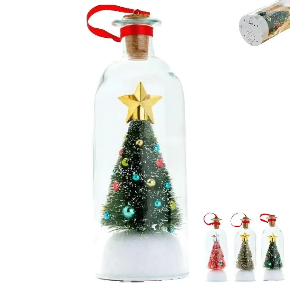 A clear glass bottle shaped like a Christmas tree with gold star topper and snowy scene inside