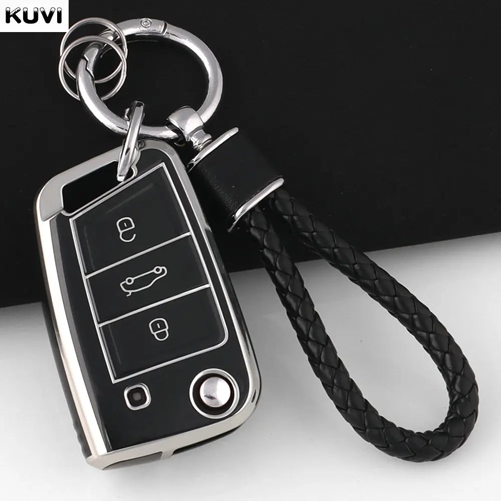 A silver TPU car key fob cover with a black strap is shown against a dark background.