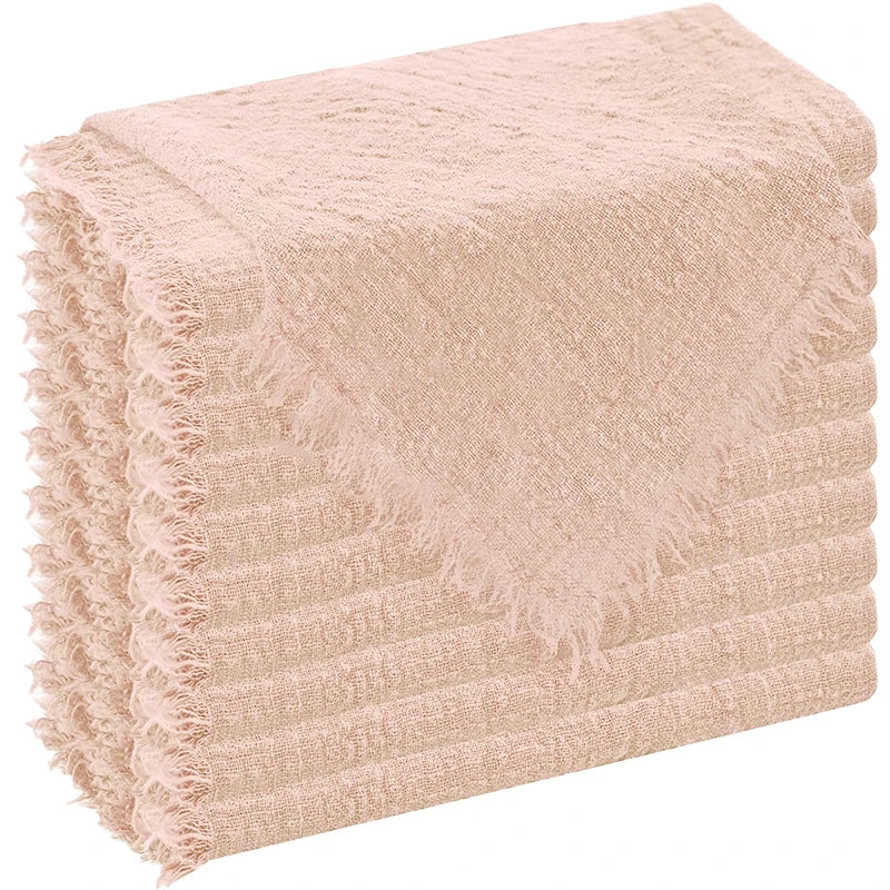 A stack of six raw-edge, light pink polyester cloth napkins.