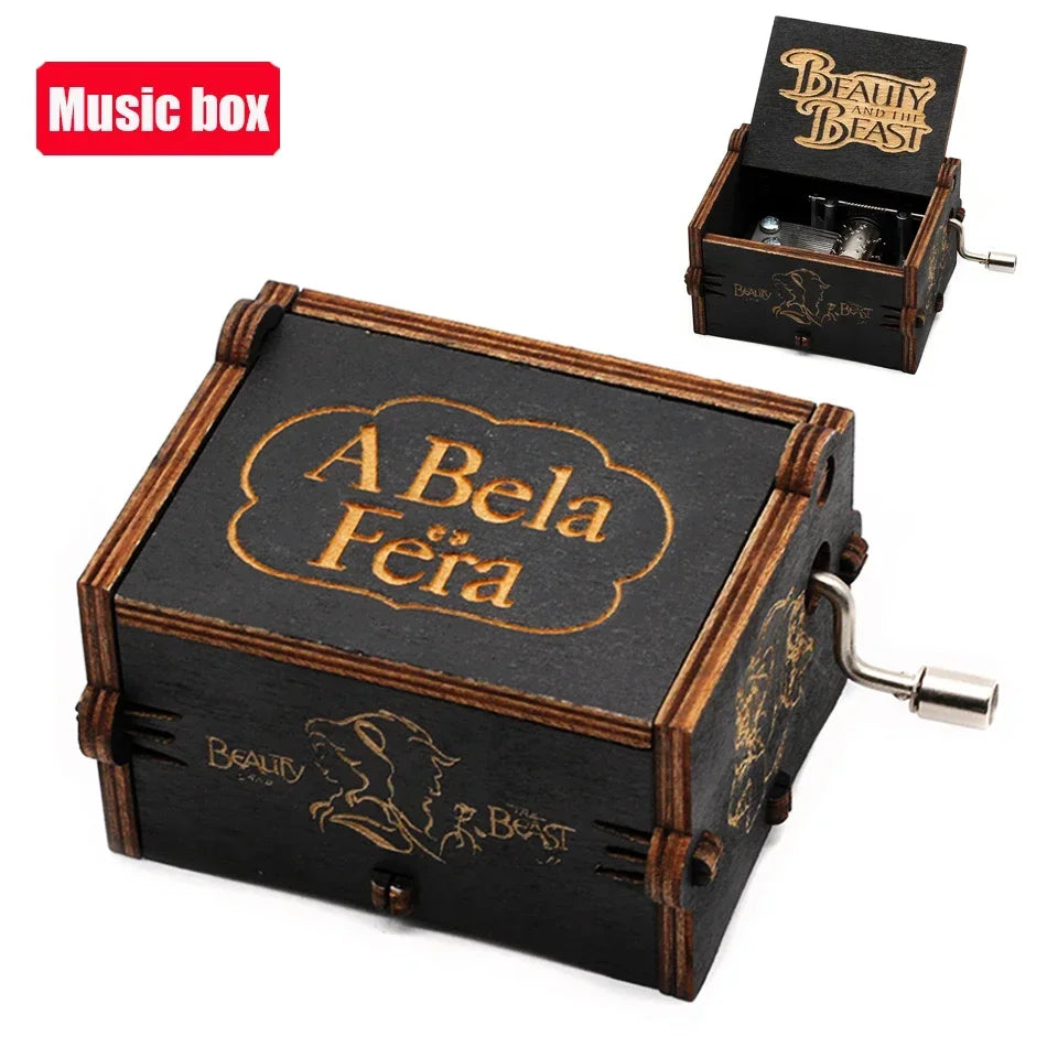 A vintage hand-crank wooden music box with a dark wood finish and gold lettering, shown next to its lid.