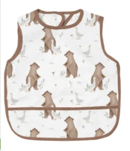A beige waterproof baby feeding bib with a sleeveless design featuring a repeating pattern of small birds.