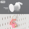 White desktop pegboard organizer with a round peg and pink animal charm attached