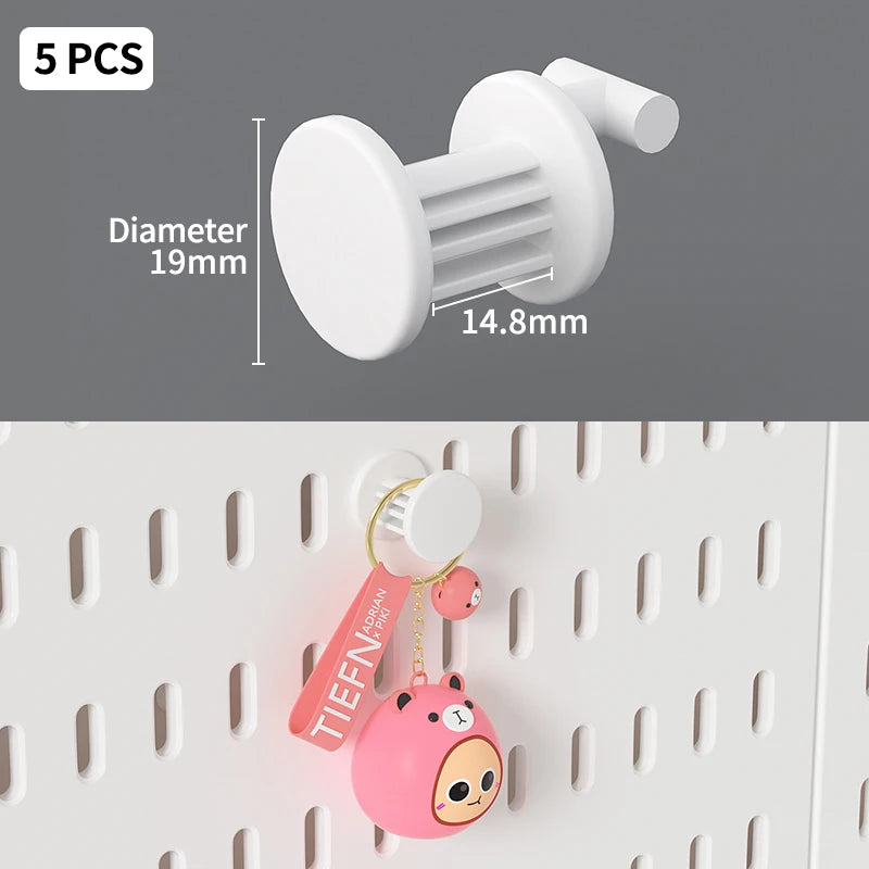 White desktop pegboard organizer with a round peg and pink animal charm attached