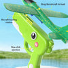 A green foam catapult airplane toy is shown with loading and ejection features against a blue background.