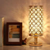 A modern crystal touch-sensor table lamp with USB charging ports sitting on a wooden surface.