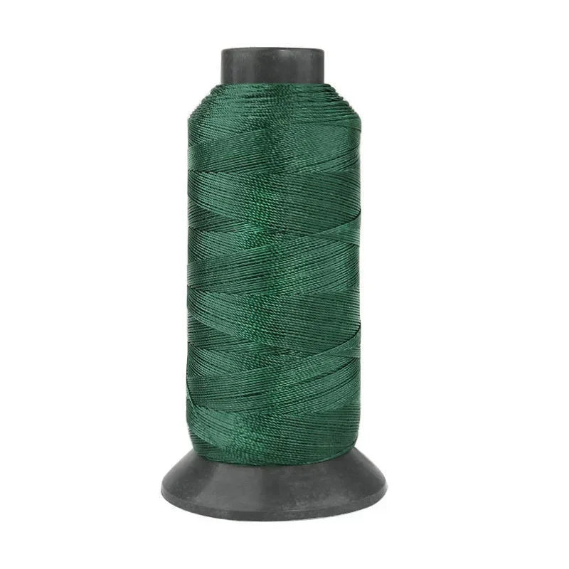 A spool of dark green heavy-duty nylon sewing thread for upholstery and denim.