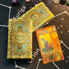 A gold foil tarot card featuring a sun motif and the number eight, set against a dark background.