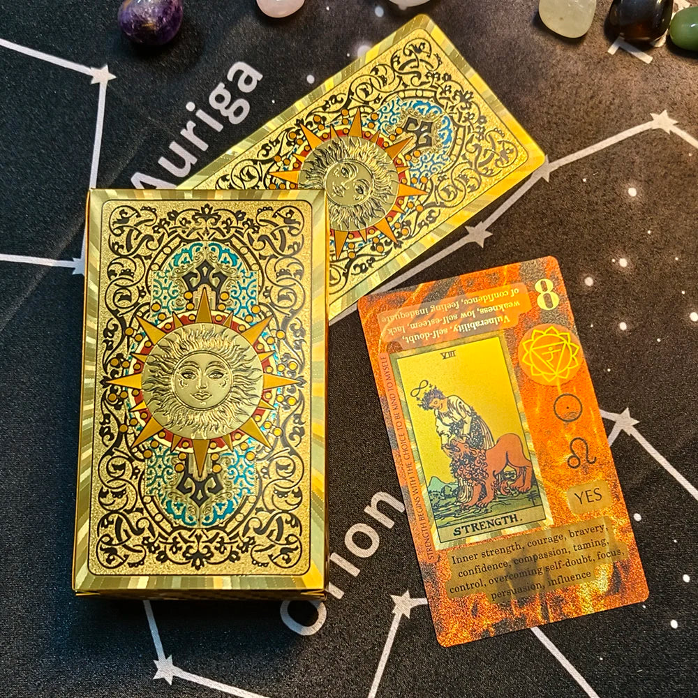 A gold foil tarot card featuring a sun motif and the number eight, set against a dark background.