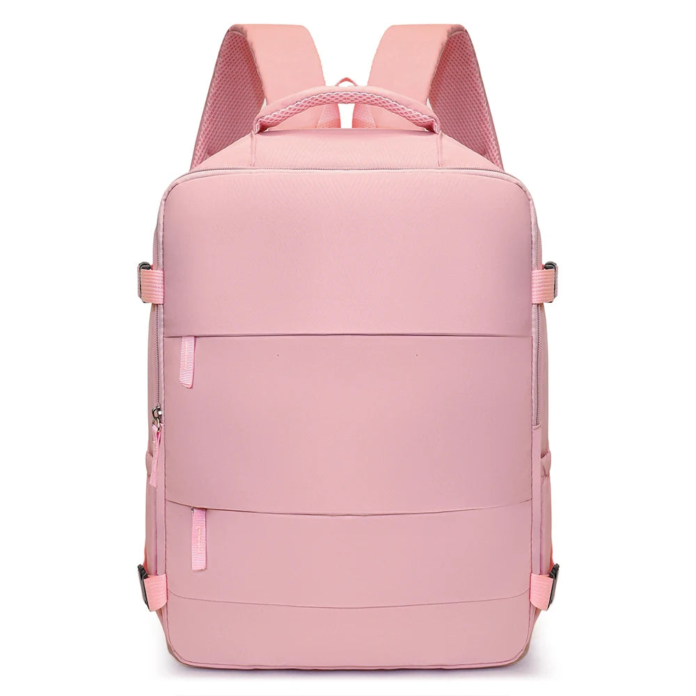 A pink compact travel backpack with pink straps and multiple horizontal compression straps.