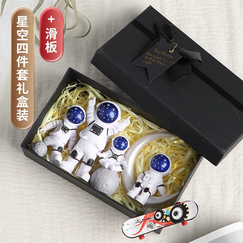 A black box contains a handcrafted astronaut figurine resin spaceman desk decor and a vertical label.
