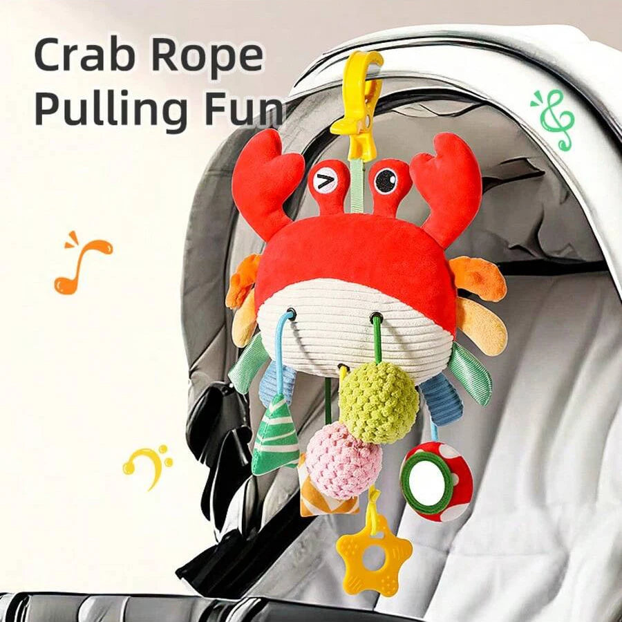 A crab rope pulling fun toy with red and orange claws and hanging colorful rattles inside a baby carrier.