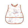 A white baby feeding bib with a brown trim featuring a sailboat design and a catch pocket.