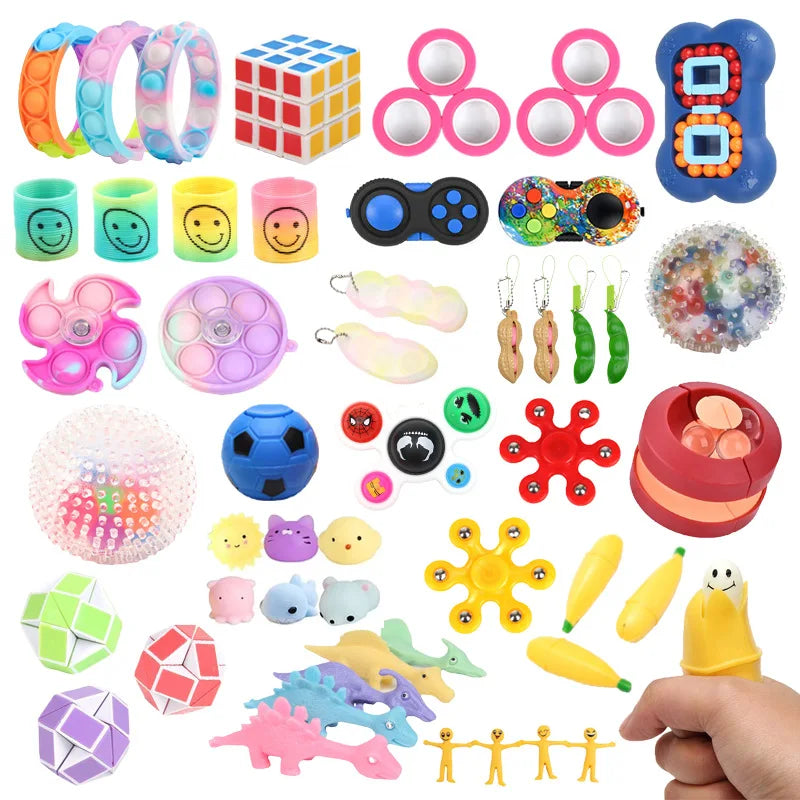 A collection of assorted fidget toys including spinners, pop-its, squishy toys, and stress relief items.