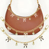 A brown leather bag with gold alloy chain handles and decorative bows.