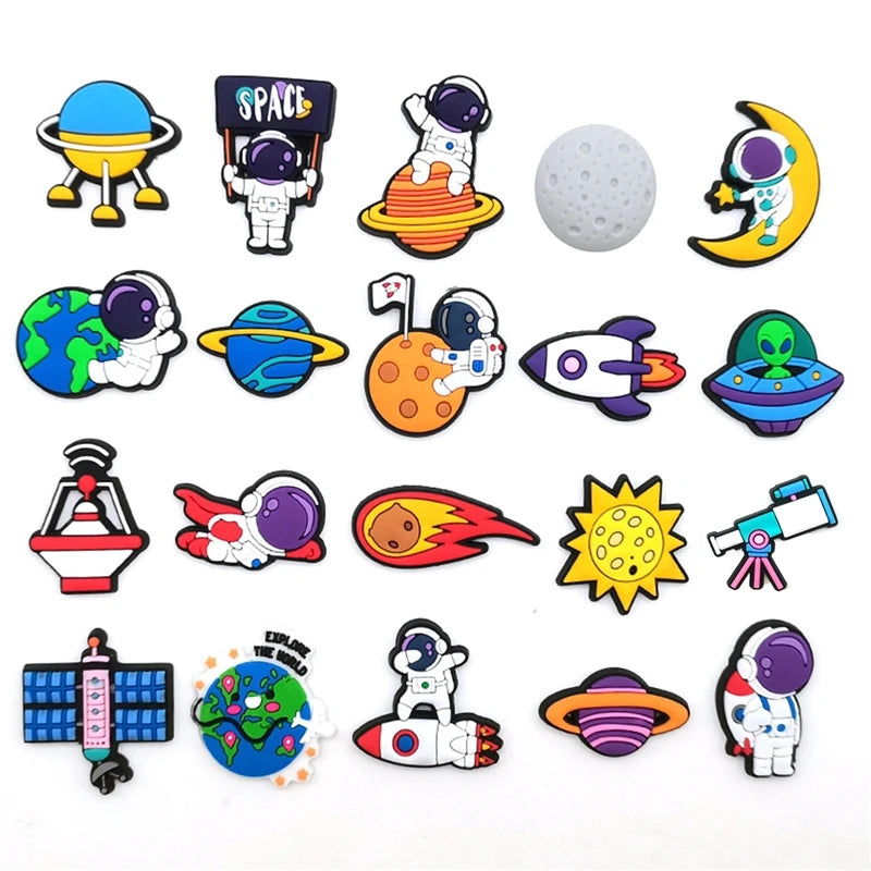 A collection of colorful PVC pins featuring space-themed designs like planets, rockets, and astronauts for decoration.