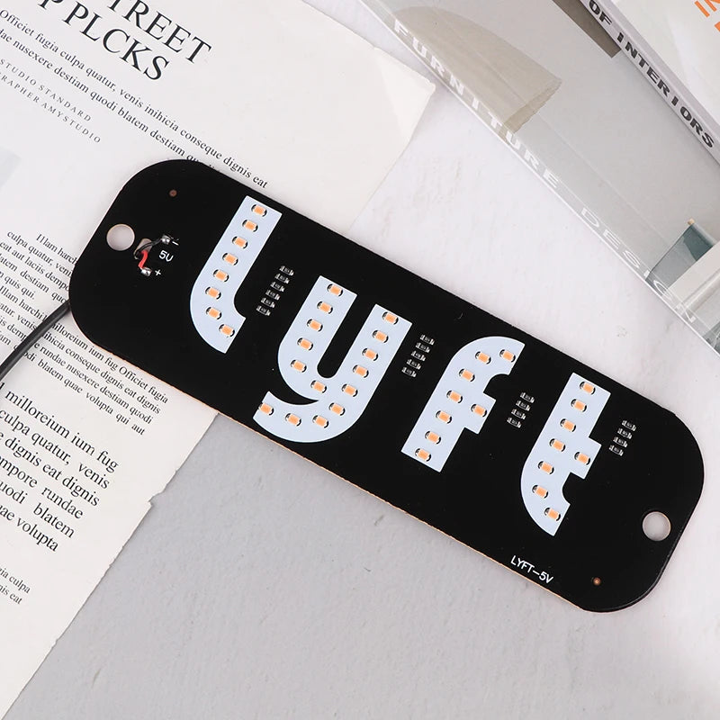 A black USB-powered LED sign shaped like the word LYFT, featuring individual light bulbs.