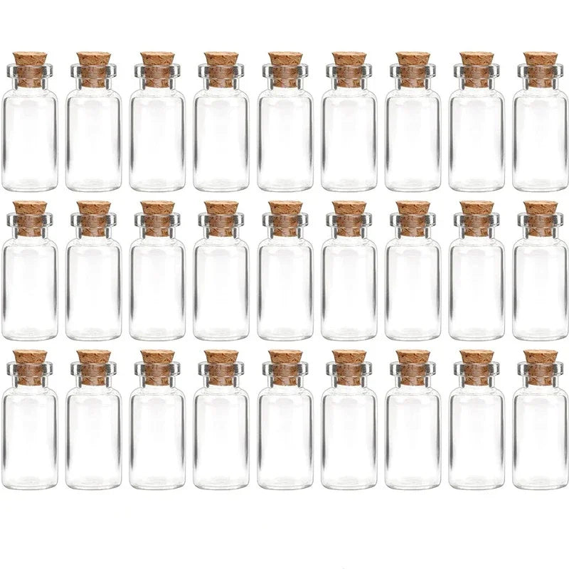 A row of small, clear glass bottles with cork stoppers arranged in a line.