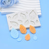 White silicone mold with leaf patterns for candle making and crafting, featuring orange and blue silicone leaves.
