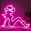 Pink neon silhouette wall sign of a person in a cowboy hat glowing on a white furry surface