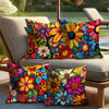 A set of colorful floral print decorative pillows resting on a light-colored outdoor sofa.