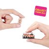 A hand holds a small, colorful miniature food surprise blind box for collectors next to a pink sign that says Collect them al