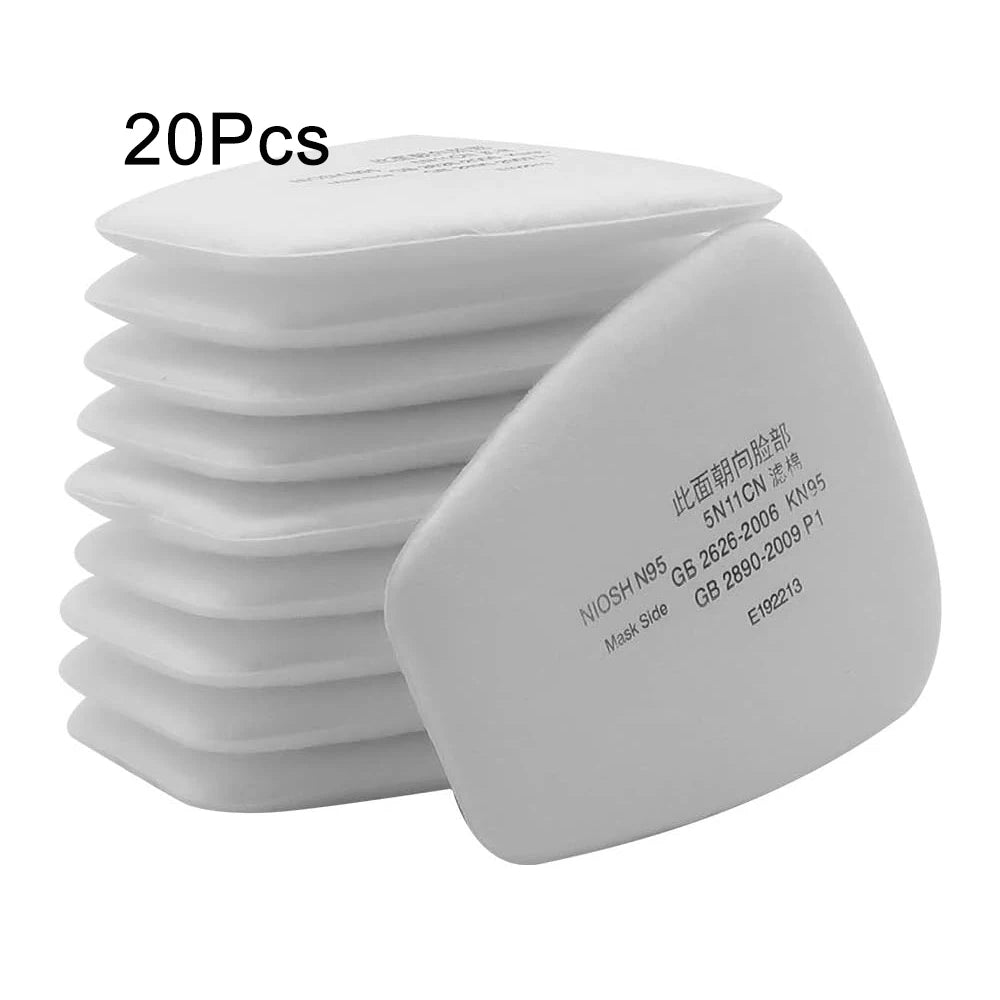 A stack of white replacement dust filter pads for respirators, showing the mask side.