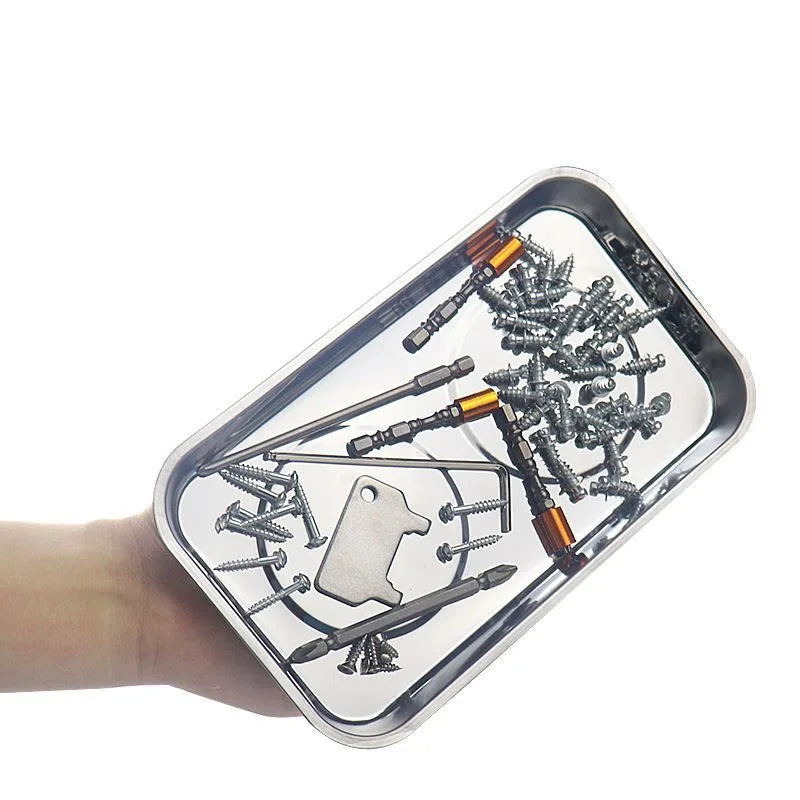 A clear magnetic parts tray filled with various hardware and small metal components.