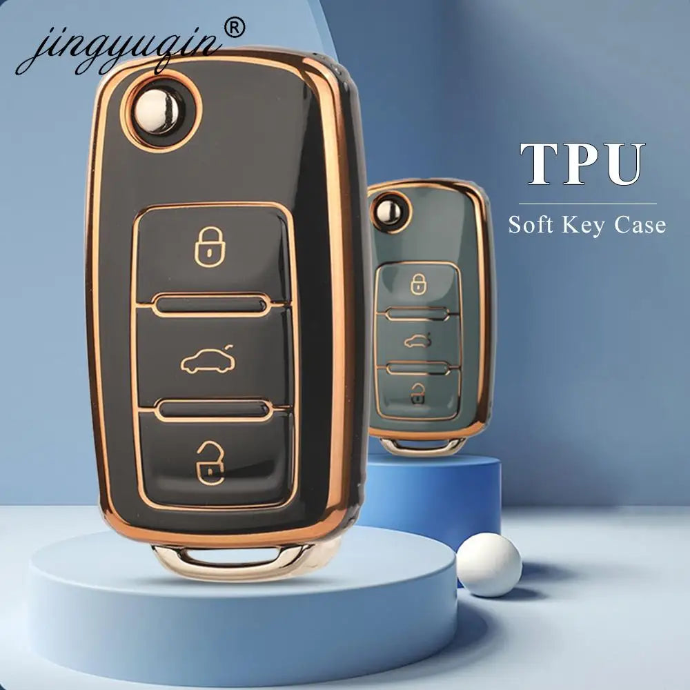 A close-up view of a black TPU silicone key case with gold accents, shown next to a light green version.