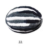 A spherical ball of black and white chenille yarn with horizontal stripes.